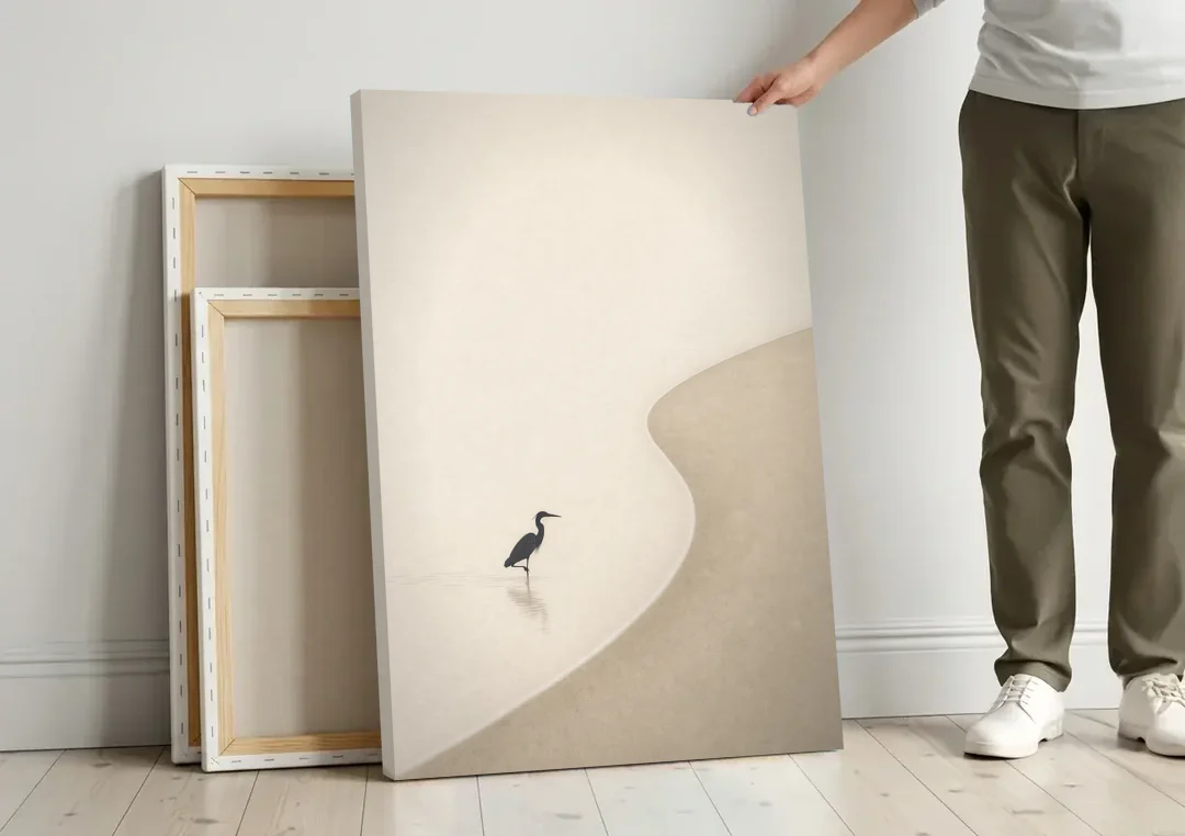 Japanese Minimalist Art of a Heron in the Shallows canvas wall art leaning against a wall next to blank canvases