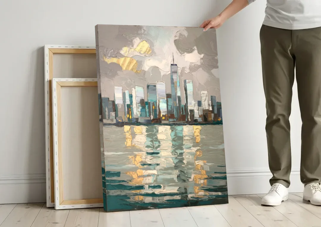 Jersey City Waterfront View canvas wall art leaning against a wall next to blank canvases