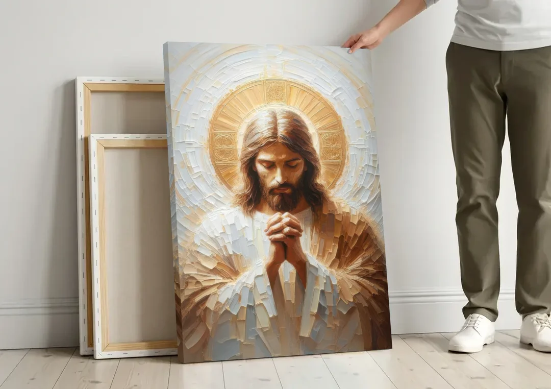 Jesus Praying canvas wall art leaning against a wall next to blank canvases