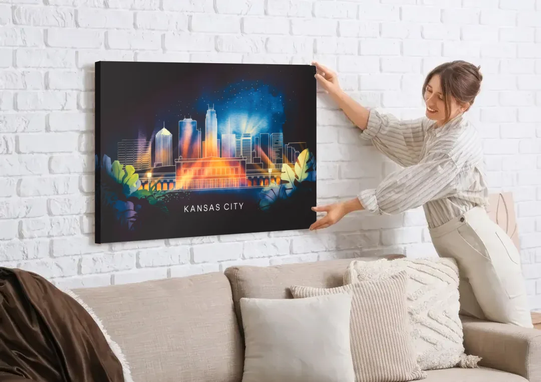Kansas City Vibrant Downtown canvas wall art being hung on a white brick wall above a sofa