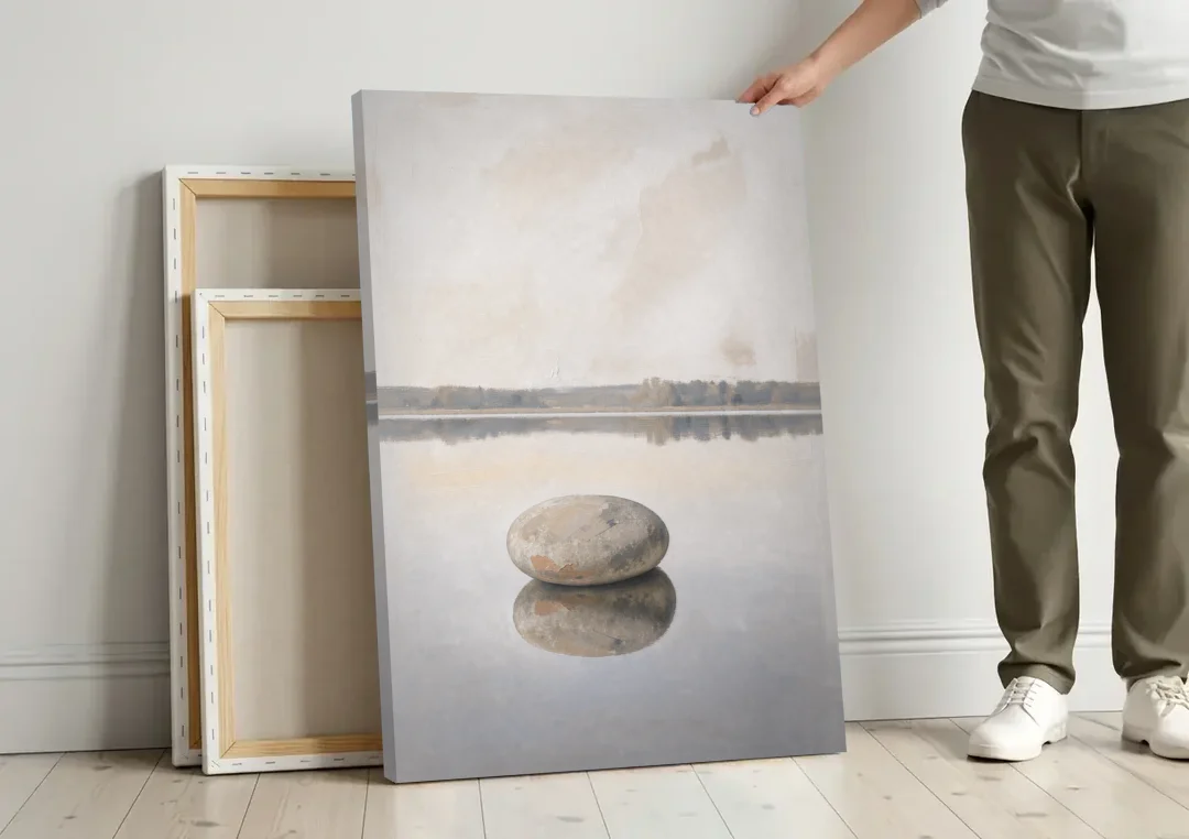 Lake Canvas Print with a Still Granite Stone canvas wall art leaning against a wall next to blank canvases
