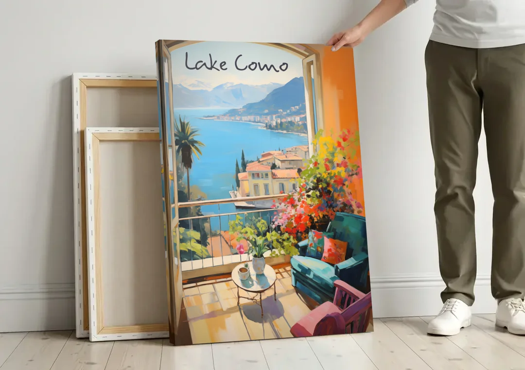 Lake Como Painting Through an Open Window canvas wall art leaning against a wall next to blank canvases
