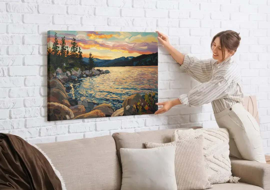 Lake Tahoe Sunset Reflections Serenity canvas wall art being hung on a white brick wall above a sofa