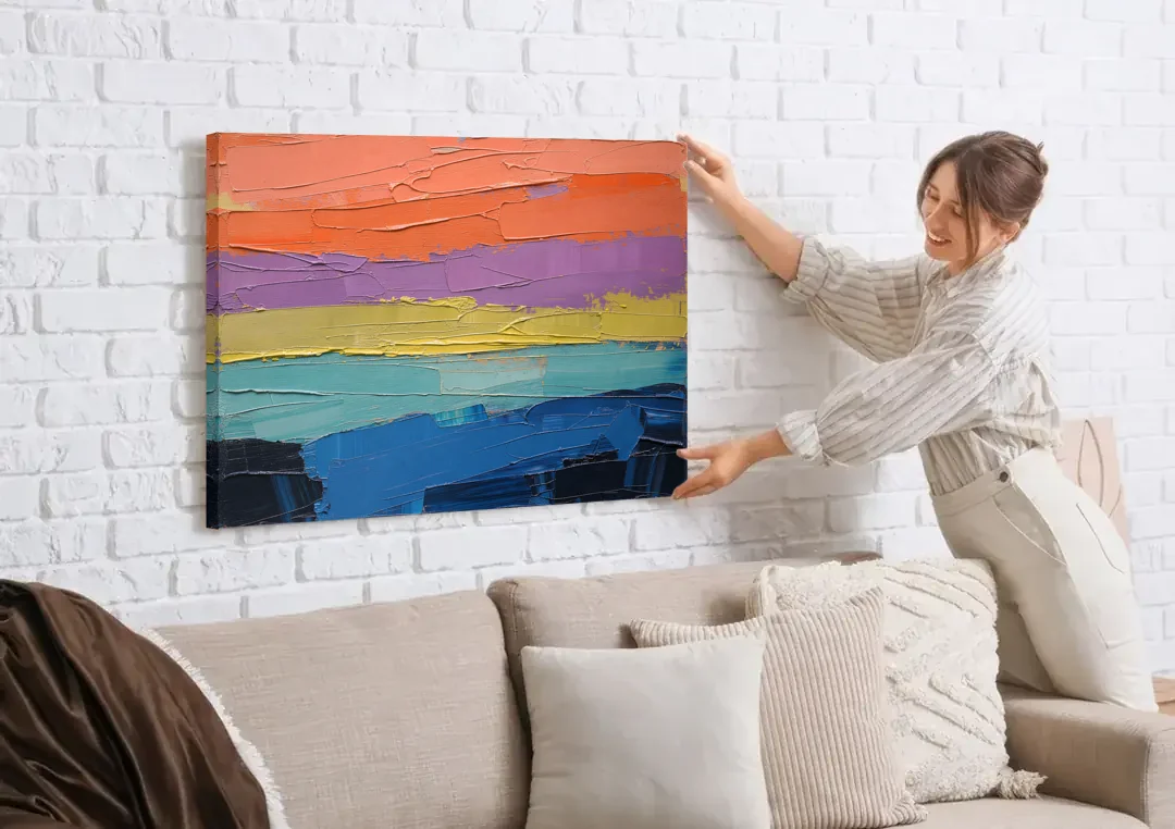 Large Abstract Coral Horizon Knife Bands canvas wall art being hung on a white brick wall above a sofa