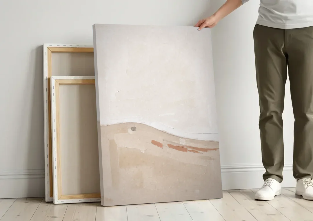 Large Minimalist Wall Art of a Clay Slope canvas wall art leaning against a wall next to blank canvases