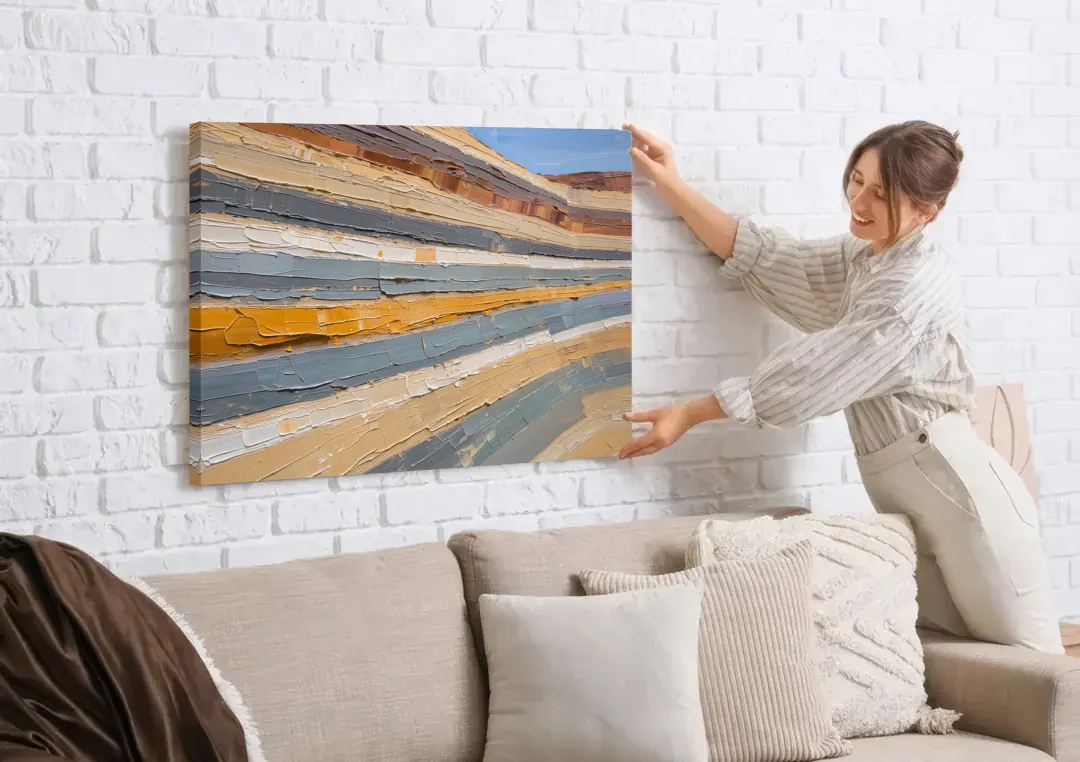 Large Office Wall Art of Layered Canyon Strata canvas wall art being hung on a white brick wall above a sofa