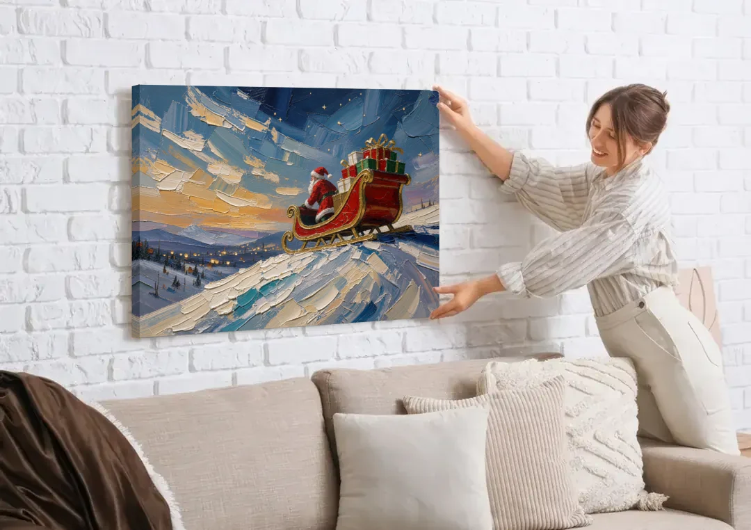 Large Santa Wall Art of the Hilltop Sleigh canvas wall art being hung on a white brick wall above a sofa