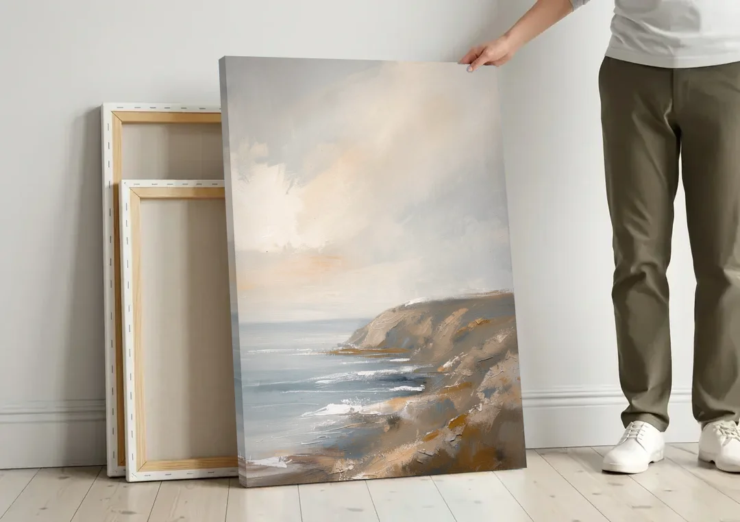 Large Vertical Wall Art of a Misty Coastal Cliff canvas wall art leaning against a wall next to blank canvases