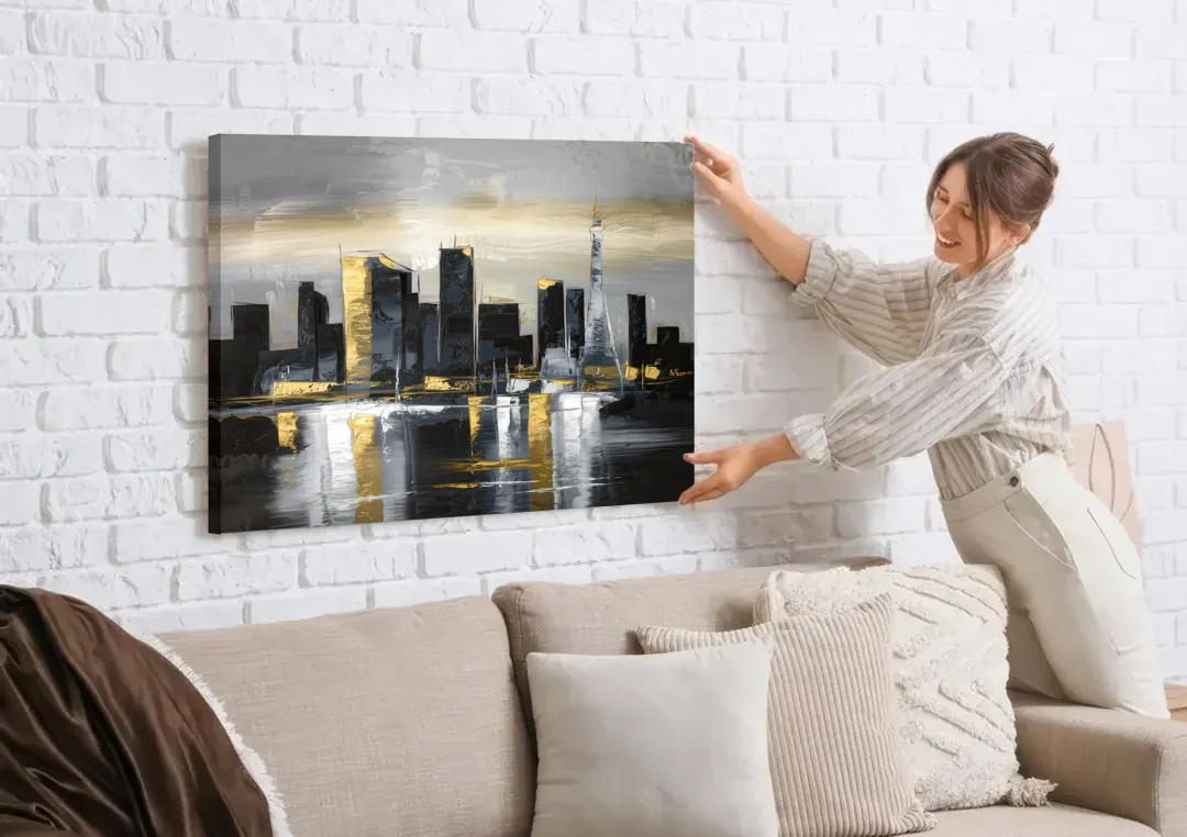 Las Vegas Black And White Skyline canvas wall art being hung on a white brick wall above a sofa