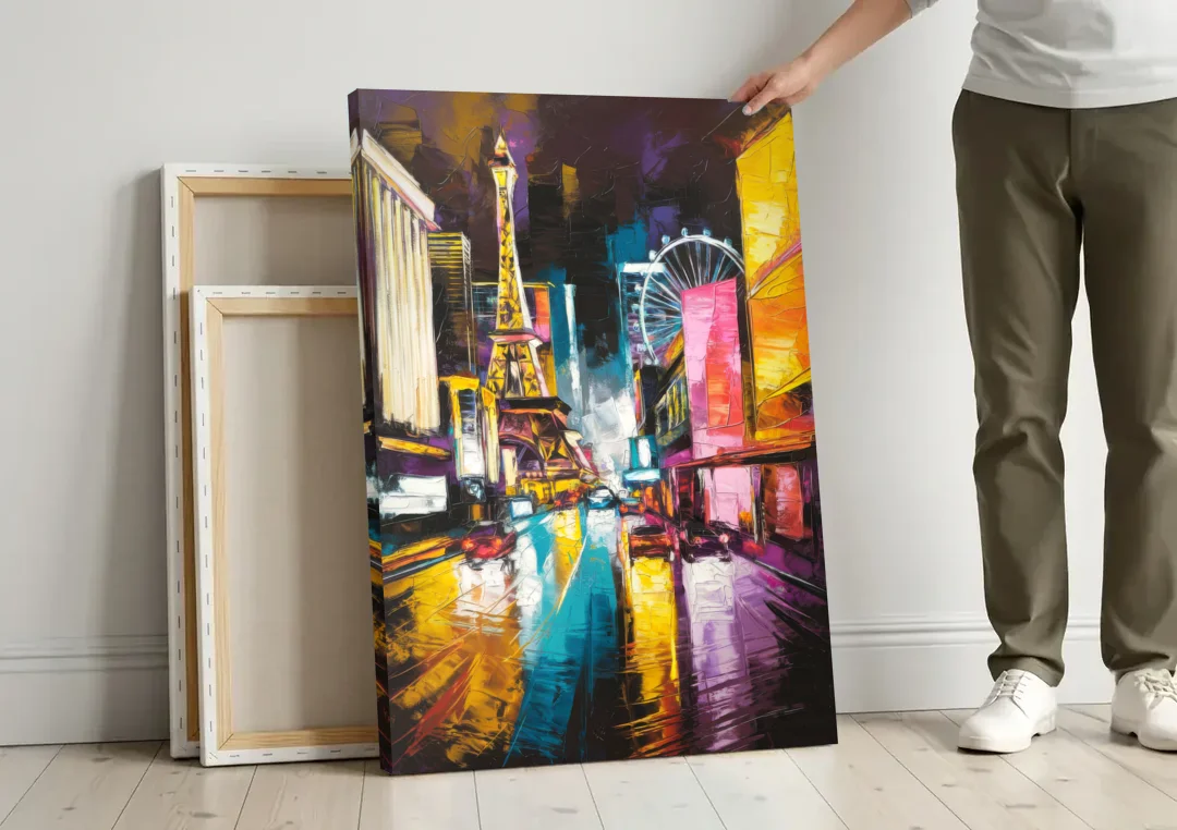 Las Vegas Downtown Energy canvas wall art leaning against a wall next to blank canvases