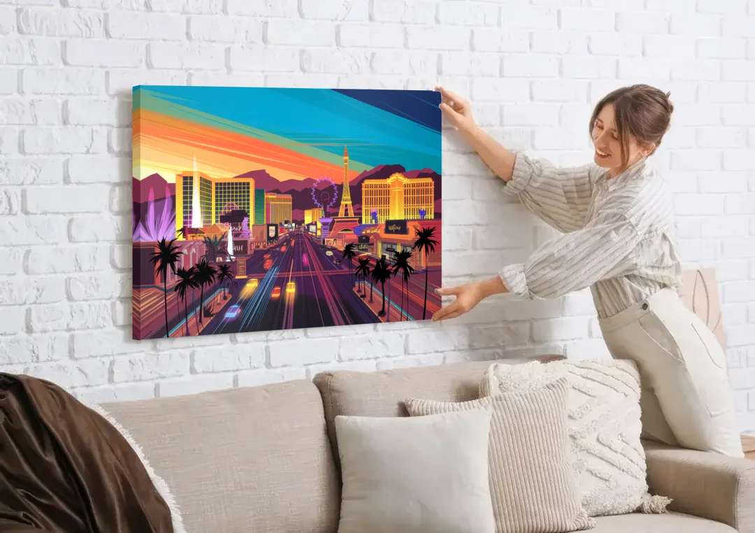 Las Vegas Iconic Strip Experience canvas wall art being hung on a white brick wall above a sofa