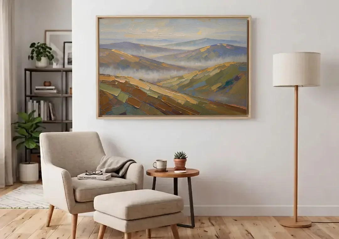 Layered Valley Ridges in Morning Haze canvas wall art above an armchair in a bright living room