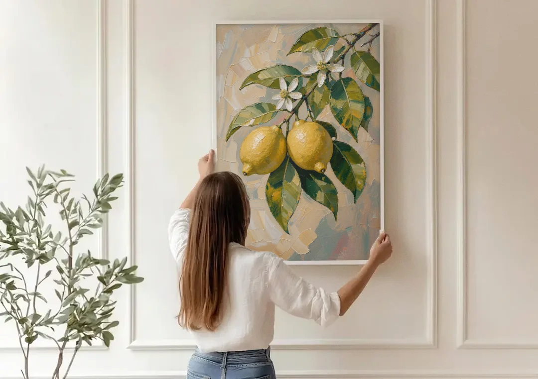Lemon Branch Painting With White Blossoms canvas wall art being hung on a paneled wall