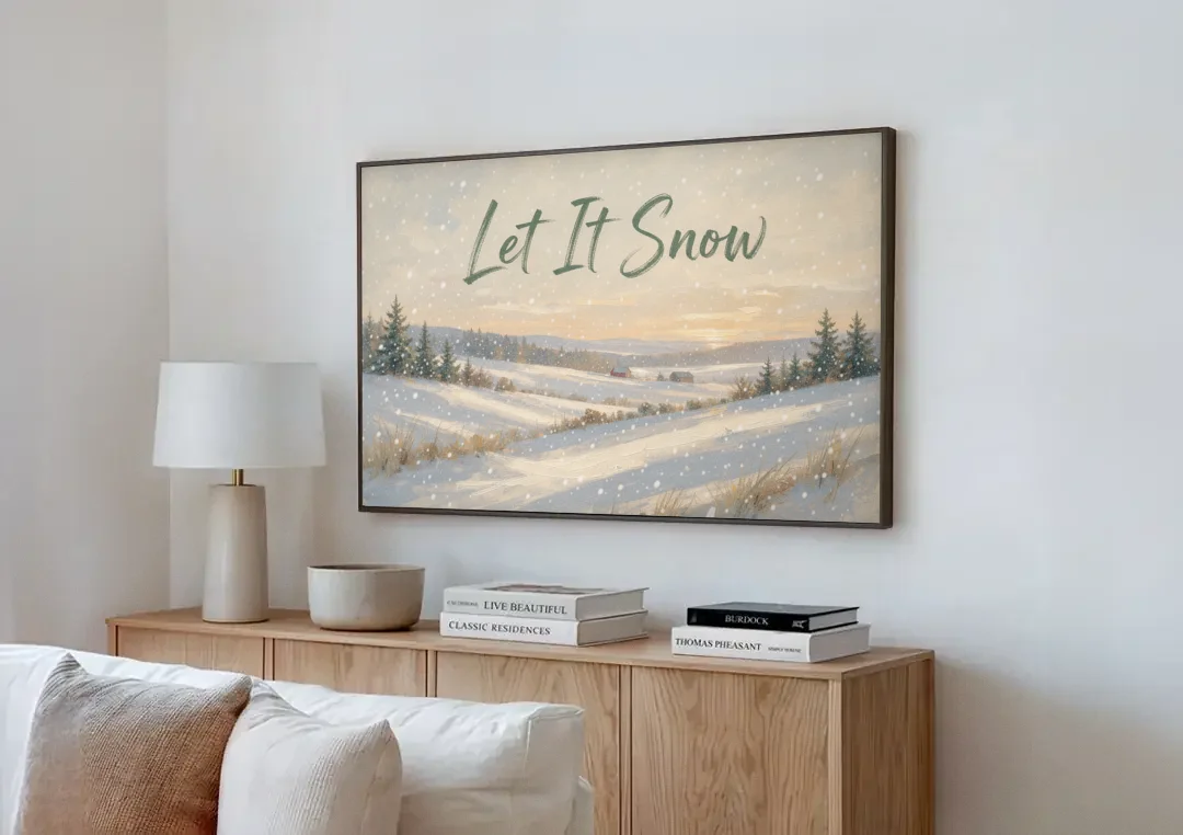Let It Snow Over a Quiet Winter Farm canvas wall art above a wooden sideboard next to a sofa