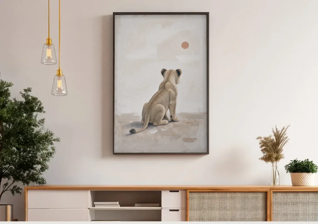 Lion Cub Gazing at a Low Pale Sun canvas wall art above a wooden sideboard under pendant lights
