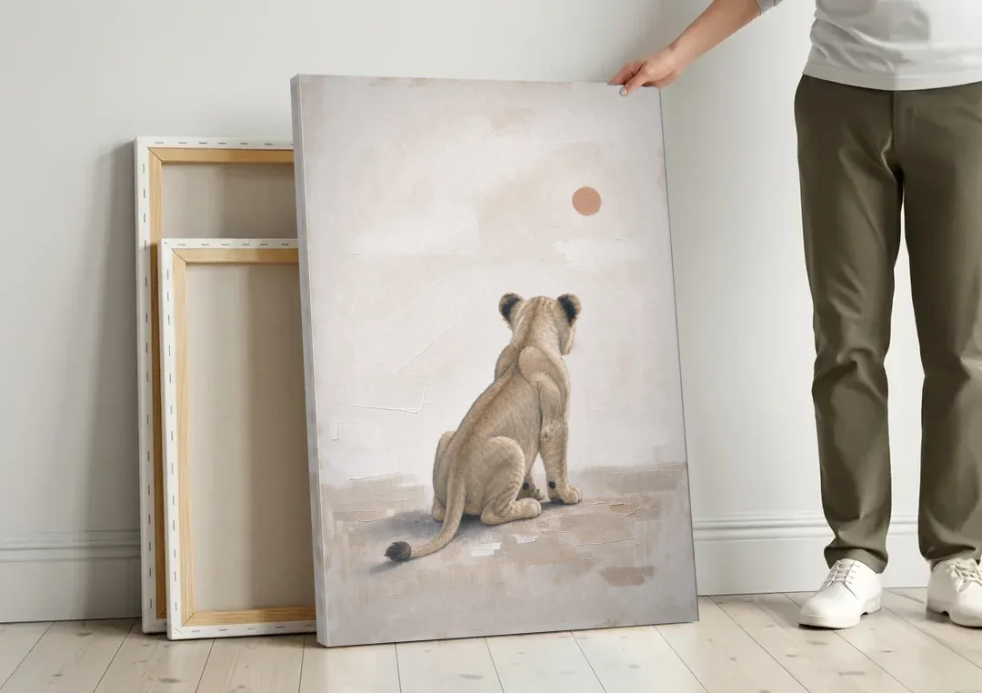 Lion Cub Gazing at a Low Pale Sun canvas wall art leaning against a wall next to blank canvases