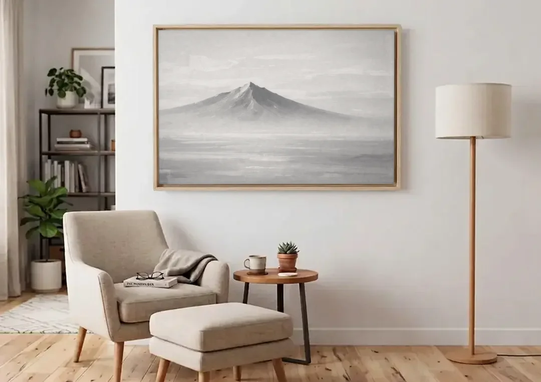 Lone Mountain Peak Above a Sea of Mist canvas wall art above an armchair in a bright living room