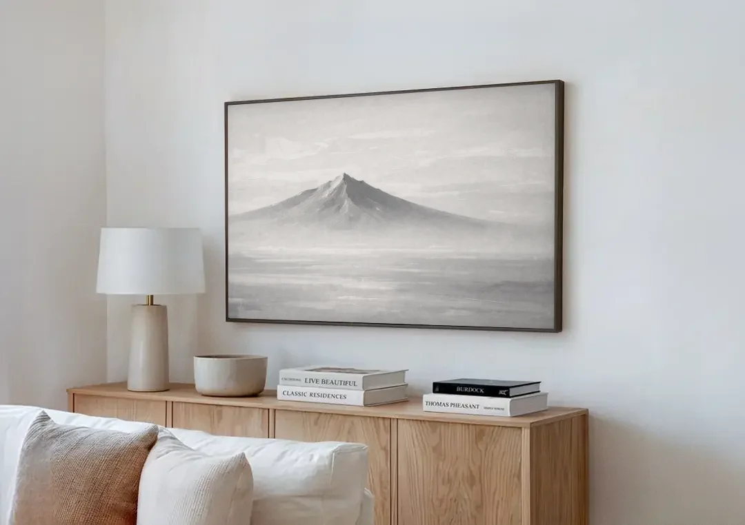 Lone Mountain Peak Above a Sea of Mist canvas wall art above a wooden sideboard next to a sofa