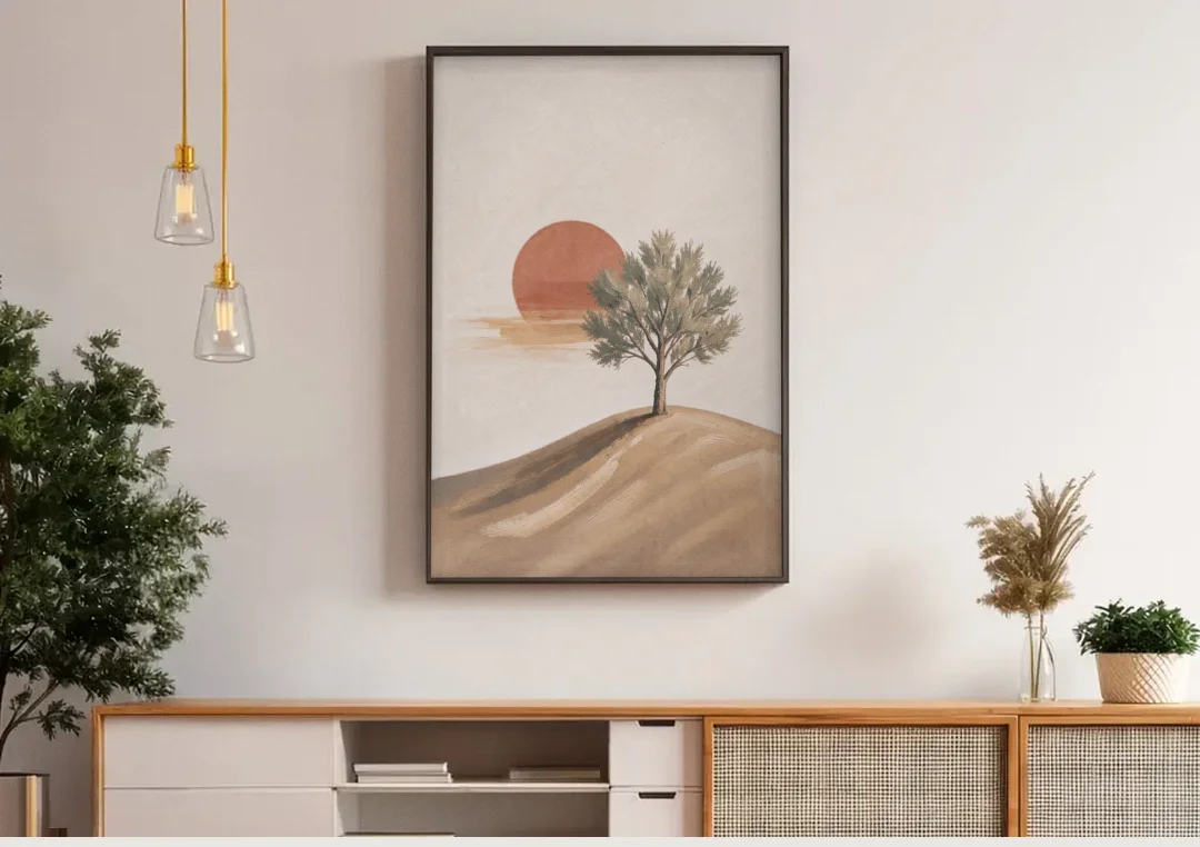 Lone Tree on a Hill Before a Rust Sun canvas wall art above a wooden sideboard under pendant lights
