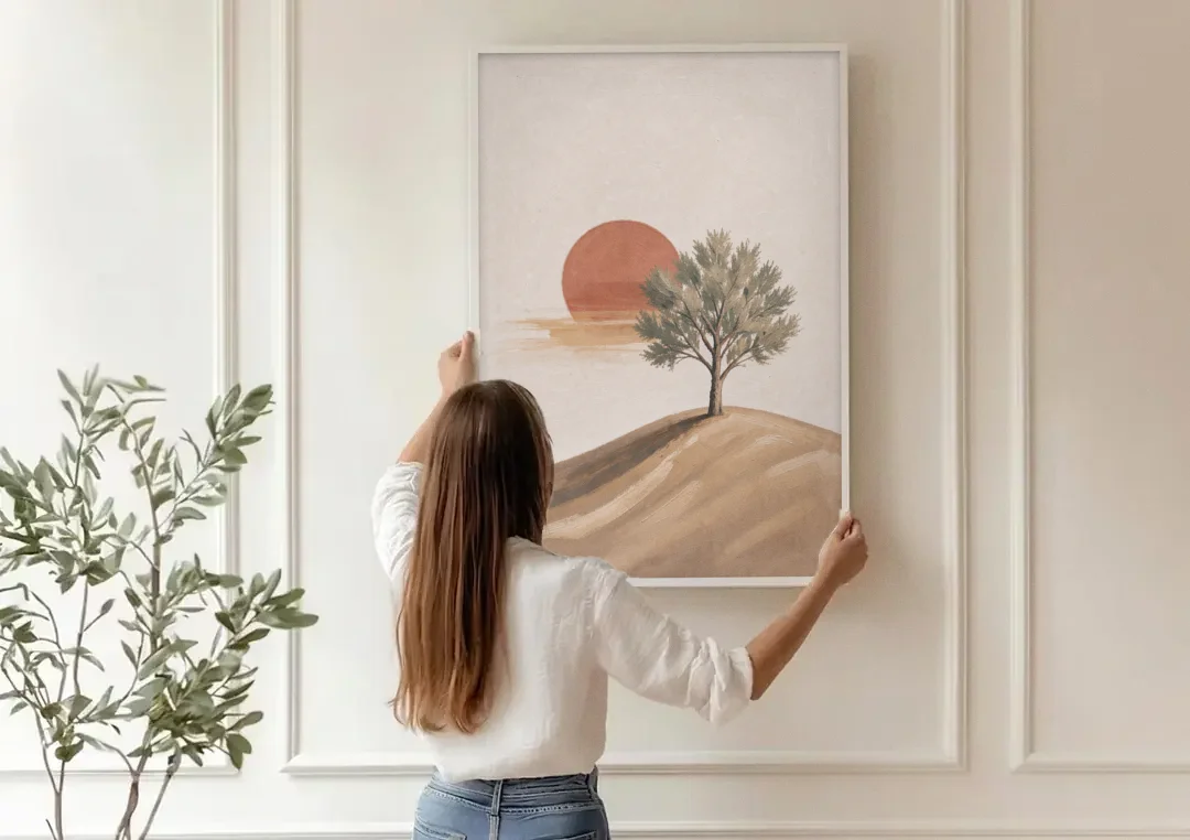 Lone Tree on a Hill Before a Rust Sun canvas wall art being hung on a paneled wall