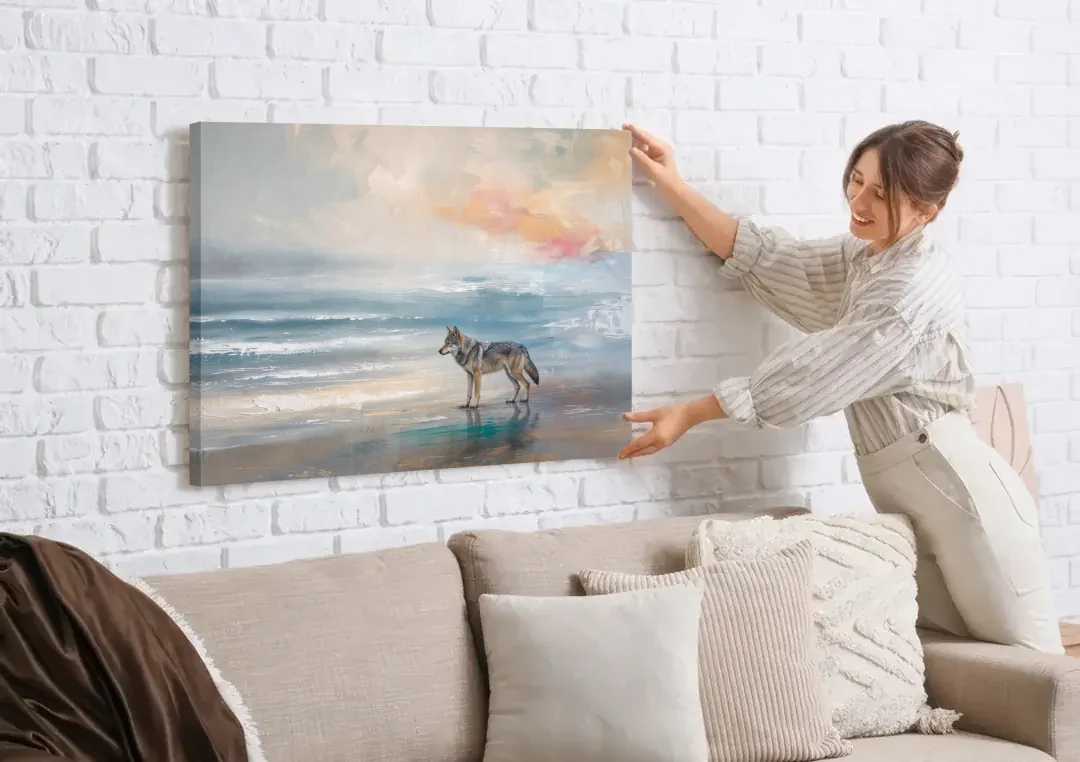 Coastal Lone Wolf on the Misty Shore canvas wall art being hung on a white brick wall above a sofa