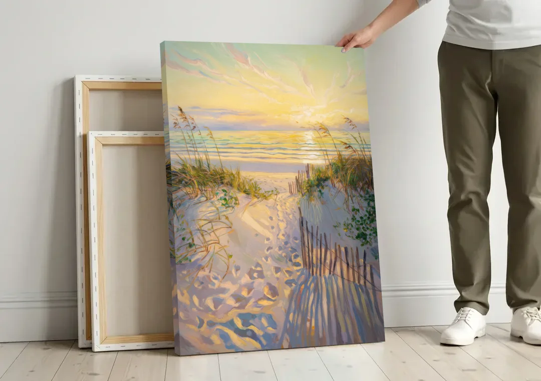 Long Beach Island Sunrise Glow canvas wall art leaning against a wall next to blank canvases