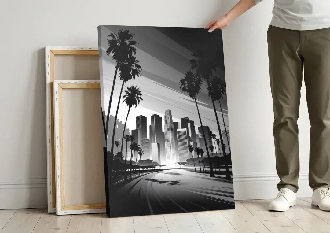 Los Angeles Black and White Cityscape Monochrome canvas wall art leaning against a wall next to blank canvases