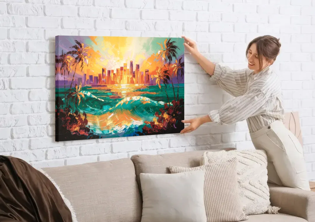 Los Angeles Sunset Over The Ocean canvas wall art being hung on a white brick wall above a sofa