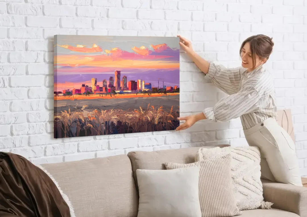 Lubbock Skyline Sunset canvas wall art being hung on a white brick wall above a sofa