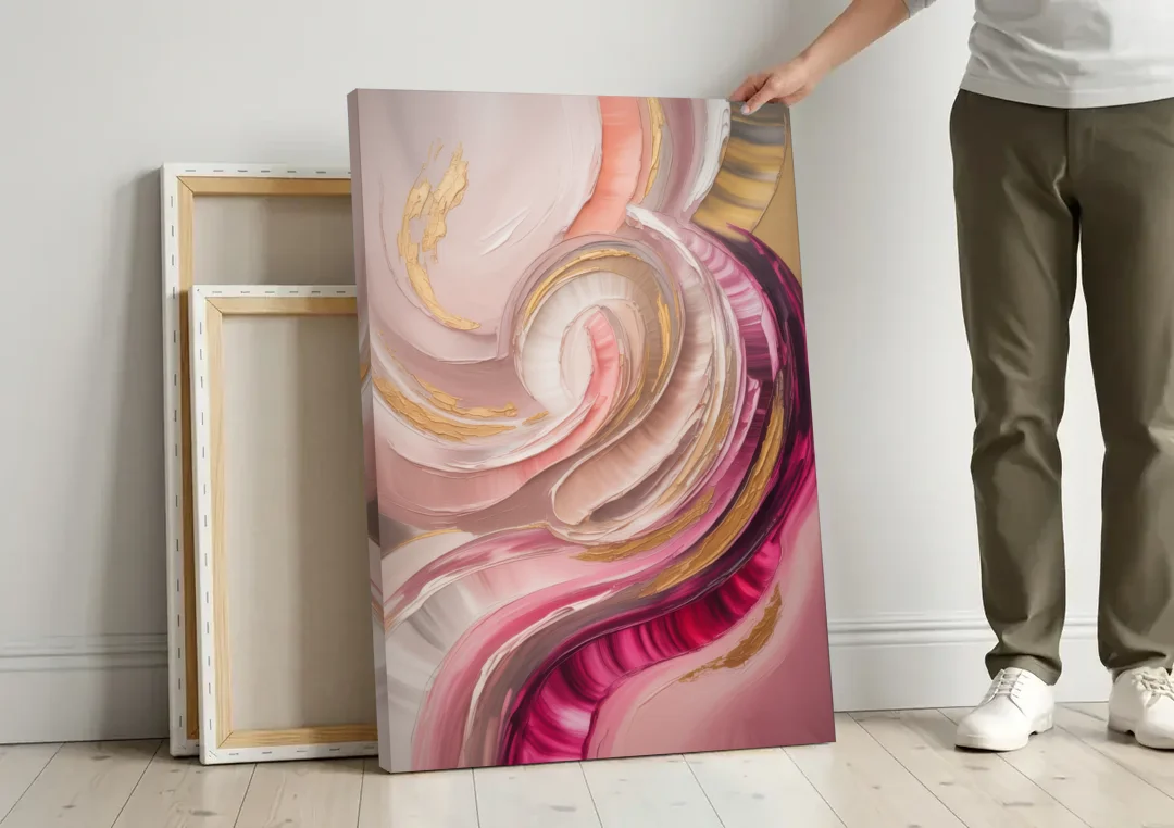 Luminous Swirl Pink Abstract canvas wall art leaning against a wall next to blank canvases