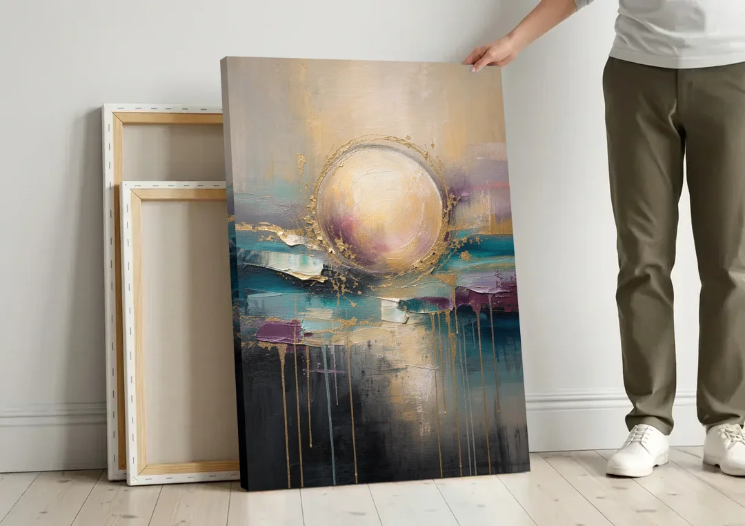 Luxury Abstract Gilded Moonrise Over Teal canvas wall art leaning against a wall next to blank canvases