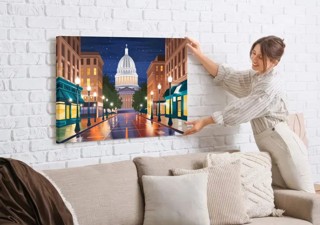 Madison Capitol Square Nights canvas wall art being hung on a white brick wall above a sofa