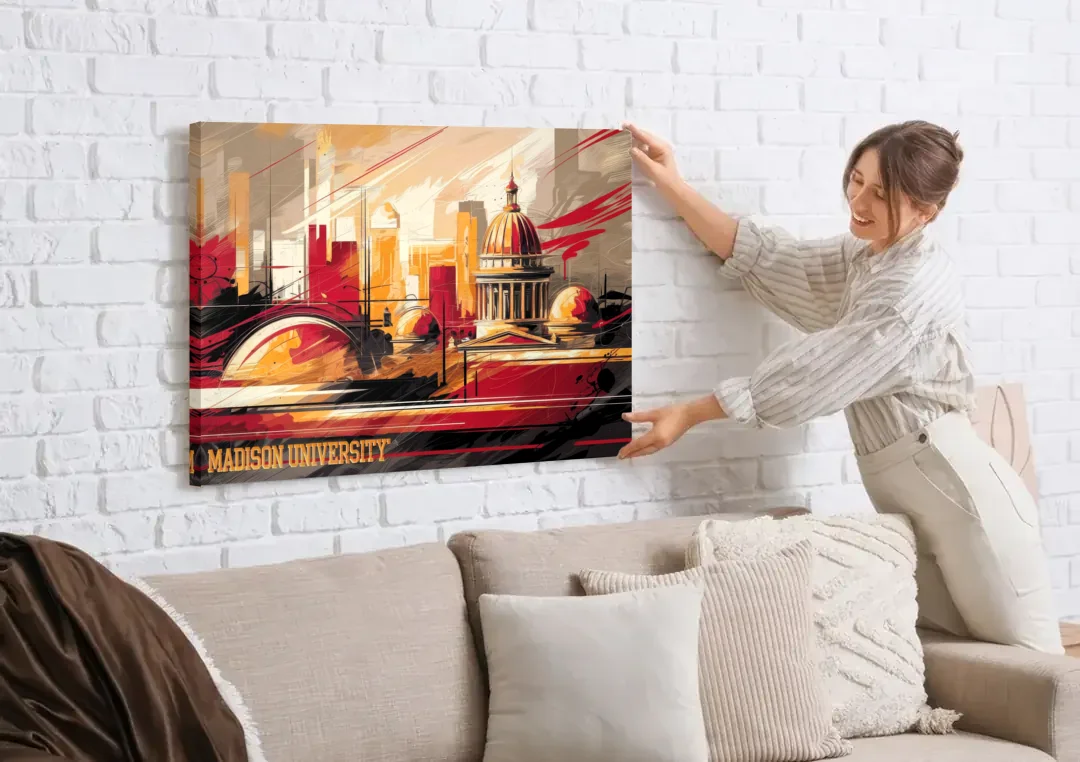 Madison University Spirit canvas wall art being hung on a white brick wall above a sofa