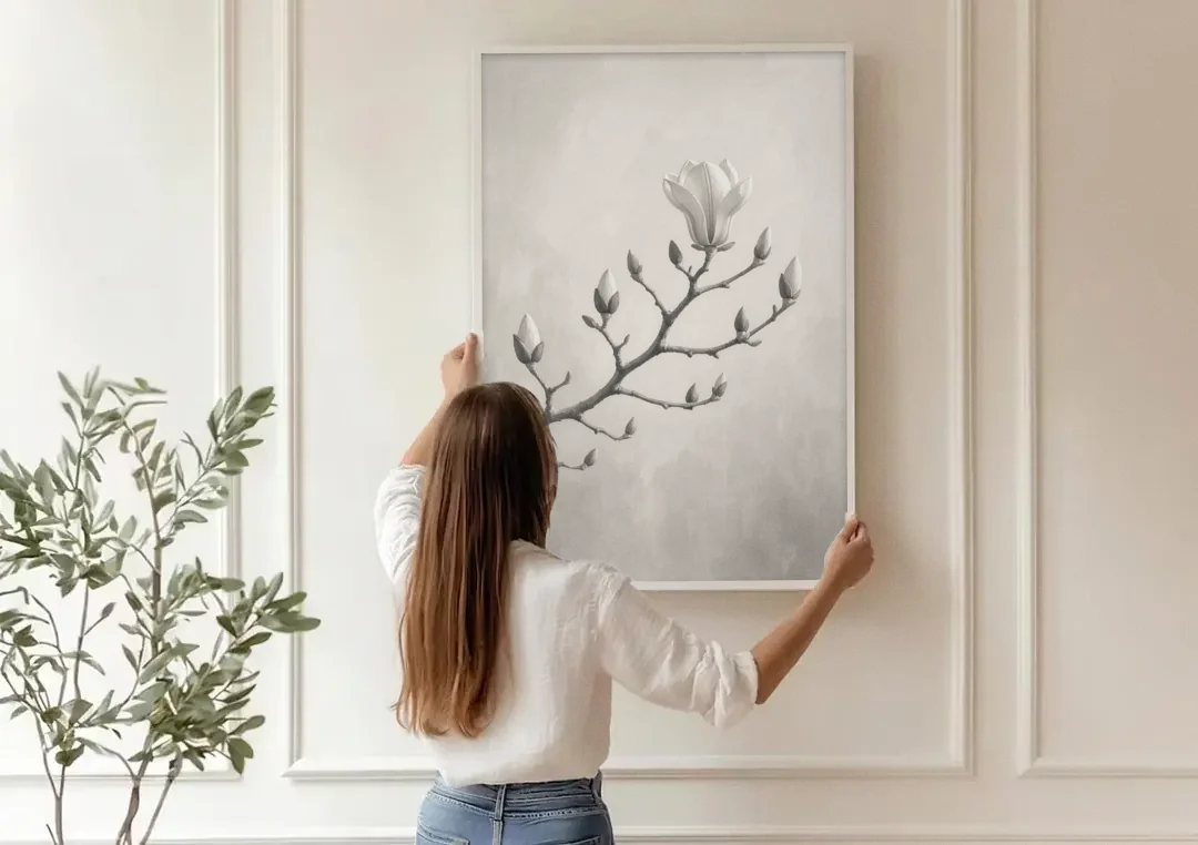 Magnolia Branch with Furry Buds and One Bloom canvas wall art being hung on a paneled wall