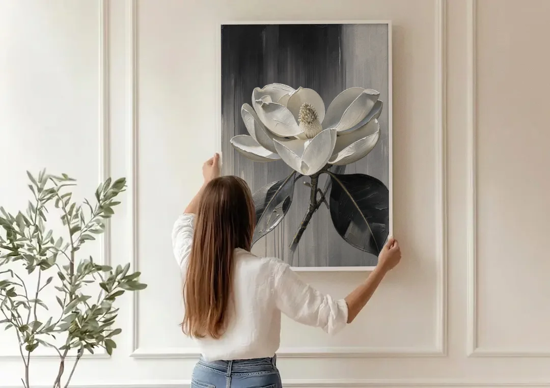 Magnolia Canvas Art with a Single White Bloom canvas wall art being hung on a paneled wall