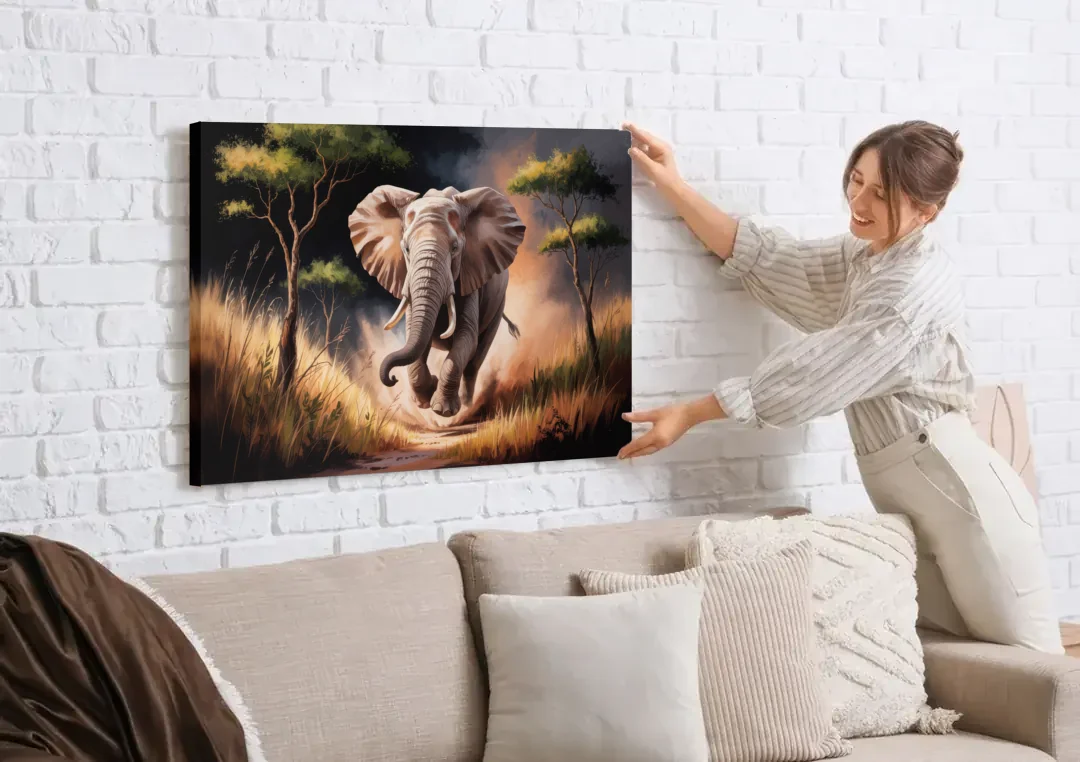 Majestic Elephant Charge canvas wall art being hung on a white brick wall above a sofa