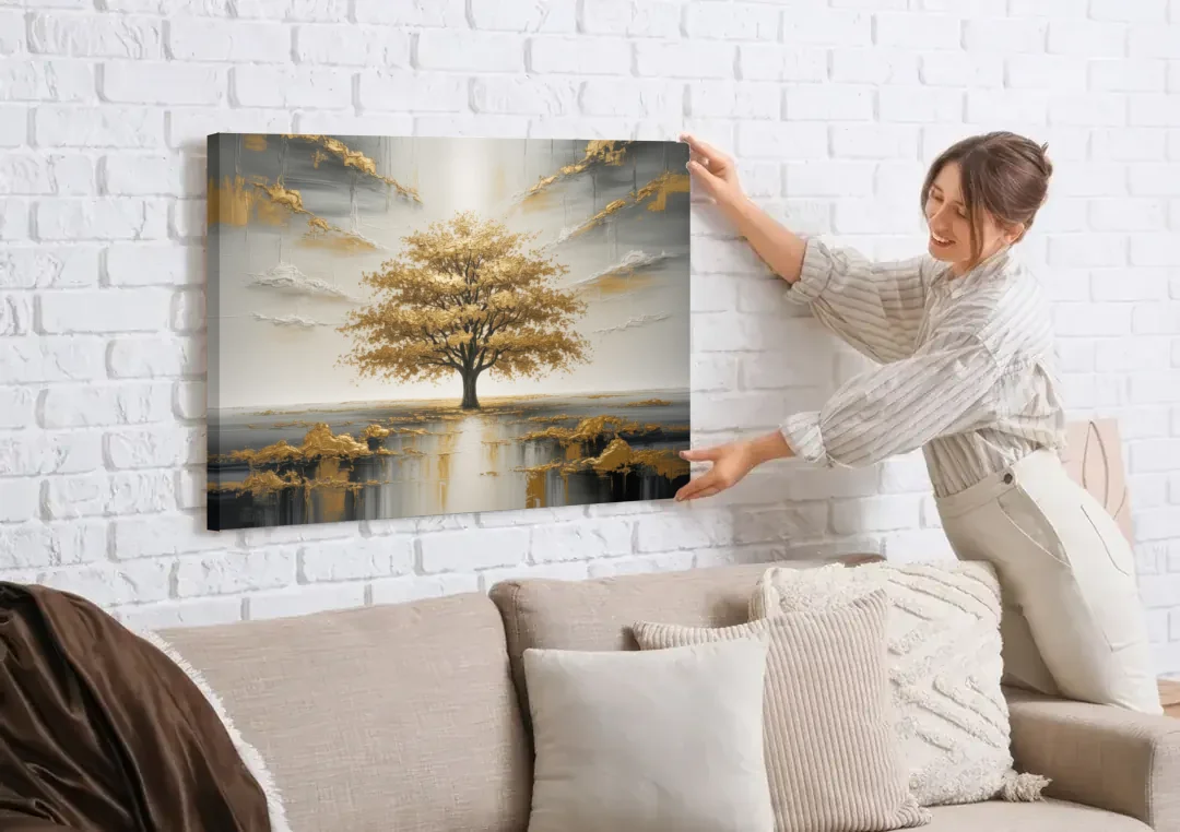 Majestic Tree Serenity White and Gold canvas wall art being hung on a white brick wall above a sofa