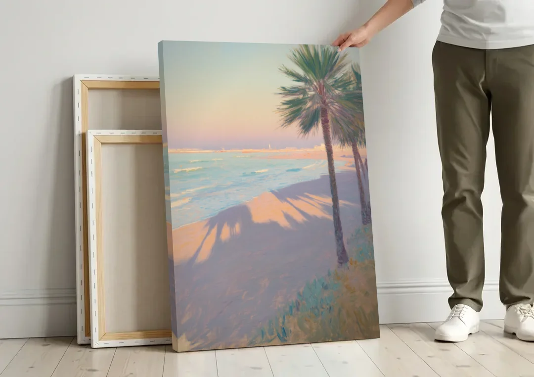 Malvarrosa Beach canvas wall art leaning against a wall next to blank canvases