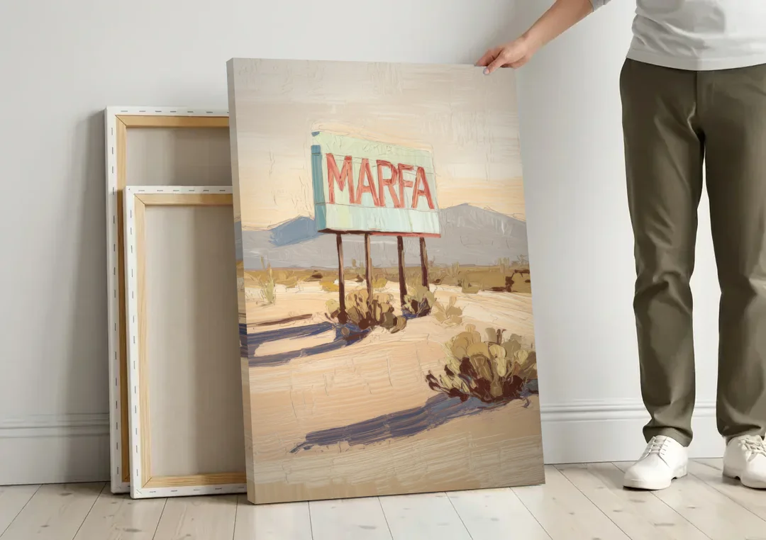 Marfa Iconic Sign canvas wall art leaning against a wall next to blank canvases