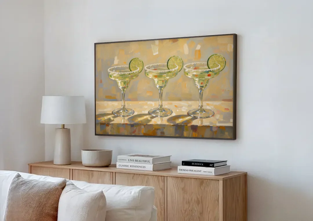Margarita Painting Trio with Lime Wheels canvas wall art above a wooden sideboard next to a sofa