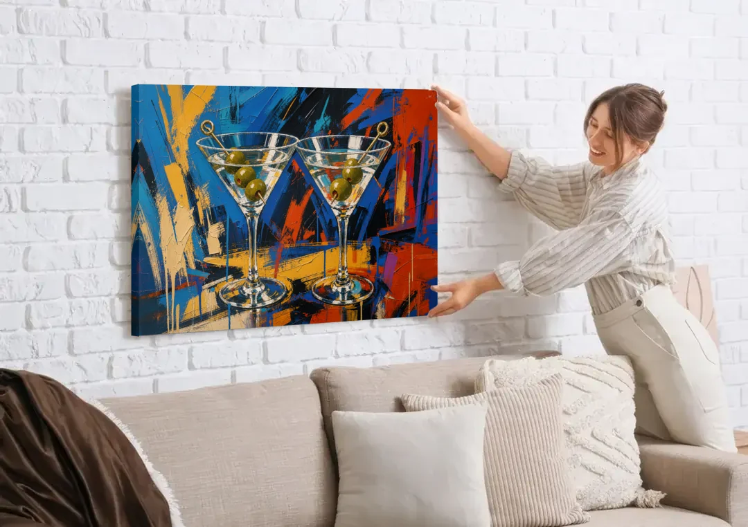 Martini Painting with Twin Olive Picks canvas wall art being hung on a white brick wall above a sofa