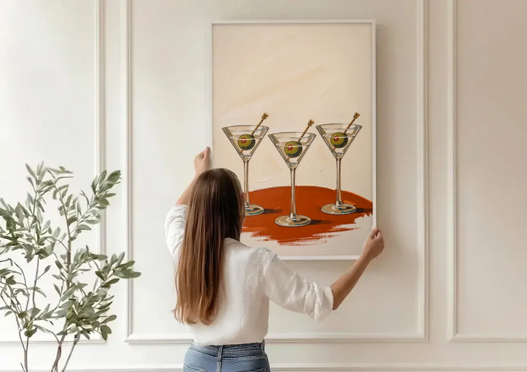 Martini Wall Art Trio with Green Olives canvas wall art being hung on a paneled wall