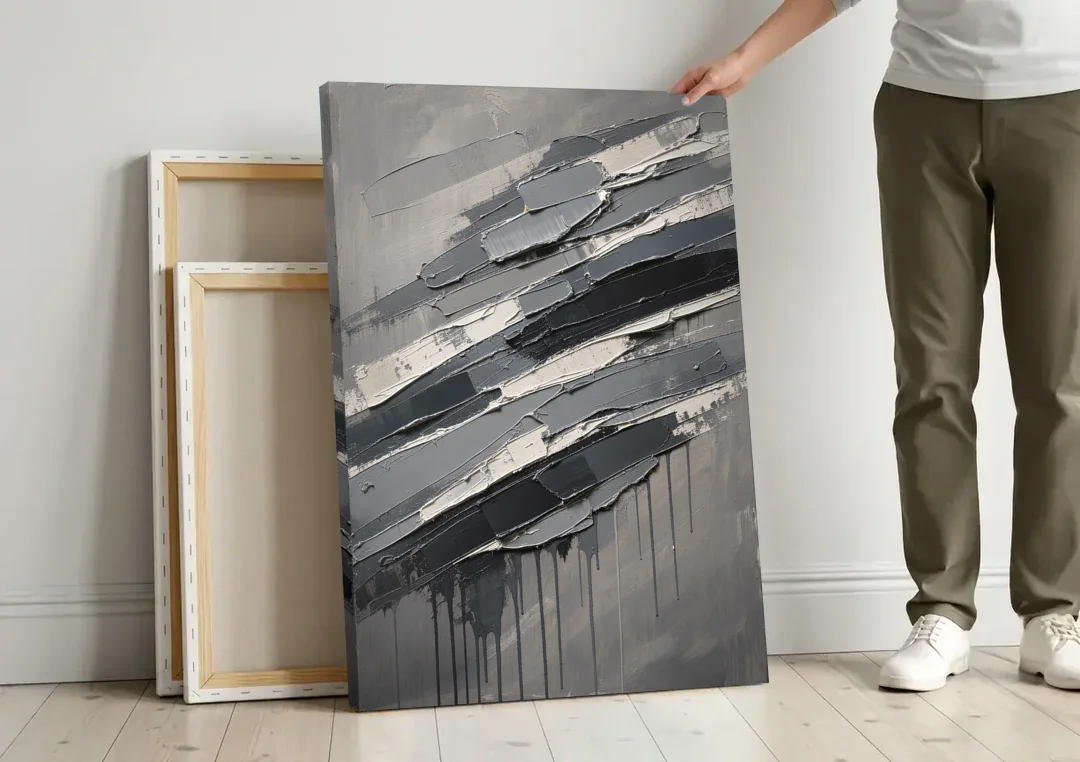 Masculine Abstract Slate Strata with White Seams canvas wall art leaning against a wall next to blank canvases