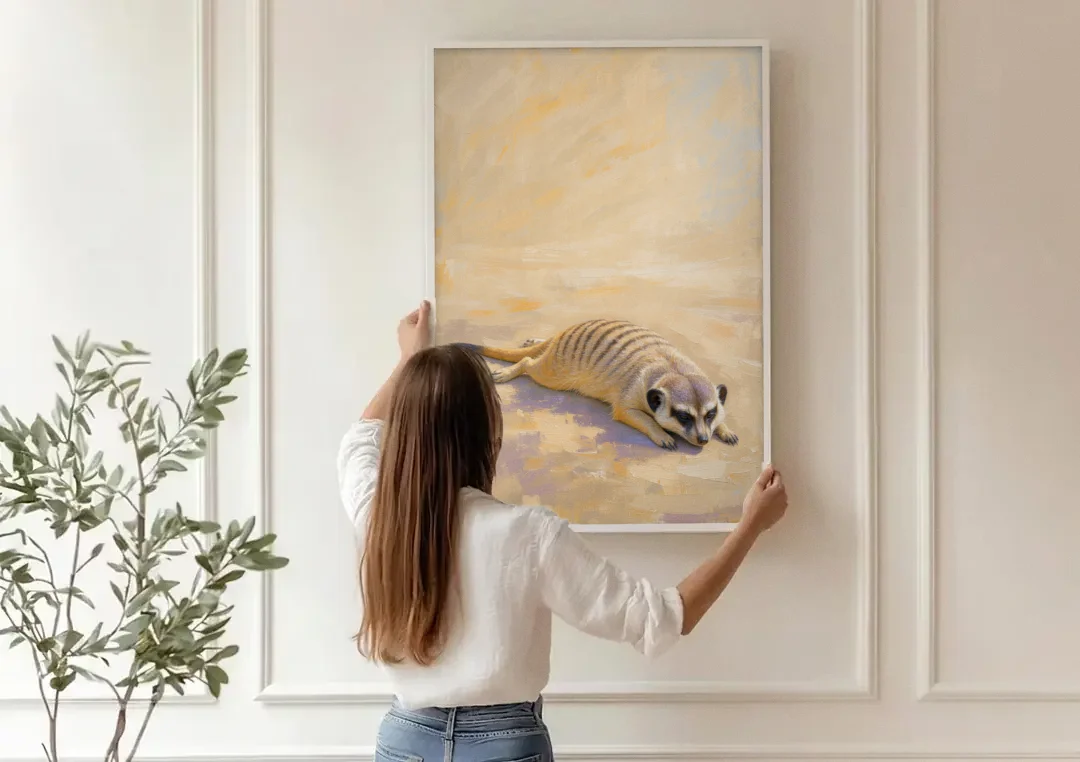 Meerkat Pup Stretched Out in the Warm Sand canvas wall art being hung on a paneled wall