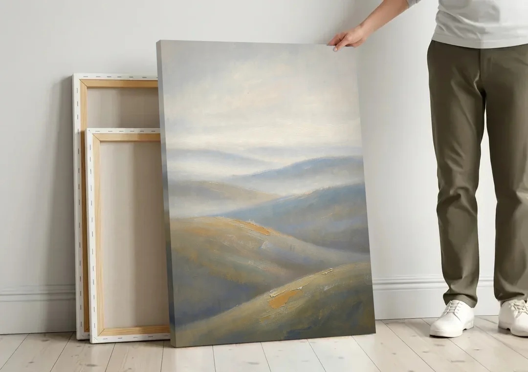 Meeting Room Decor with Misty Rolling Hills canvas wall art leaning against a wall next to blank canvases