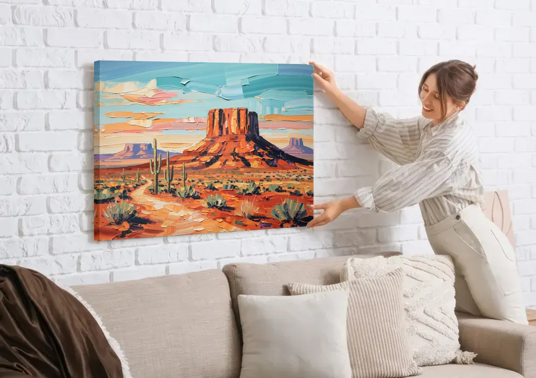 Mesa Scenic Desert canvas wall art being hung on a white brick wall above a sofa