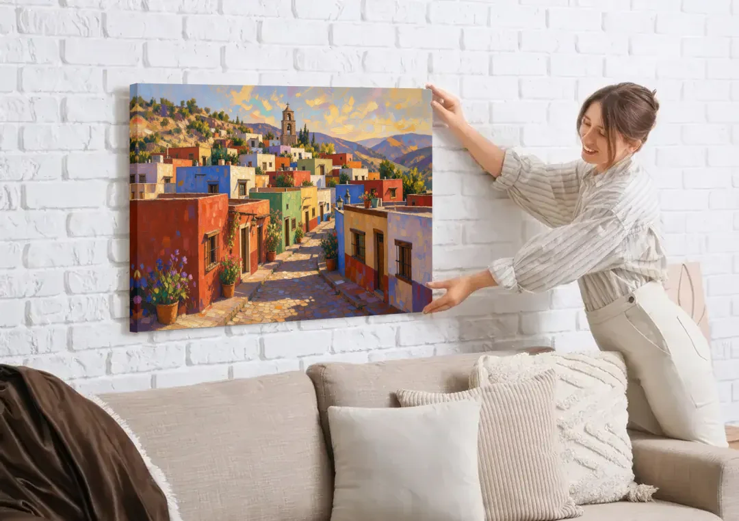 Mexican Village Painting With Hilltop Bell Tower canvas wall art being hung on a white brick wall above a sofa