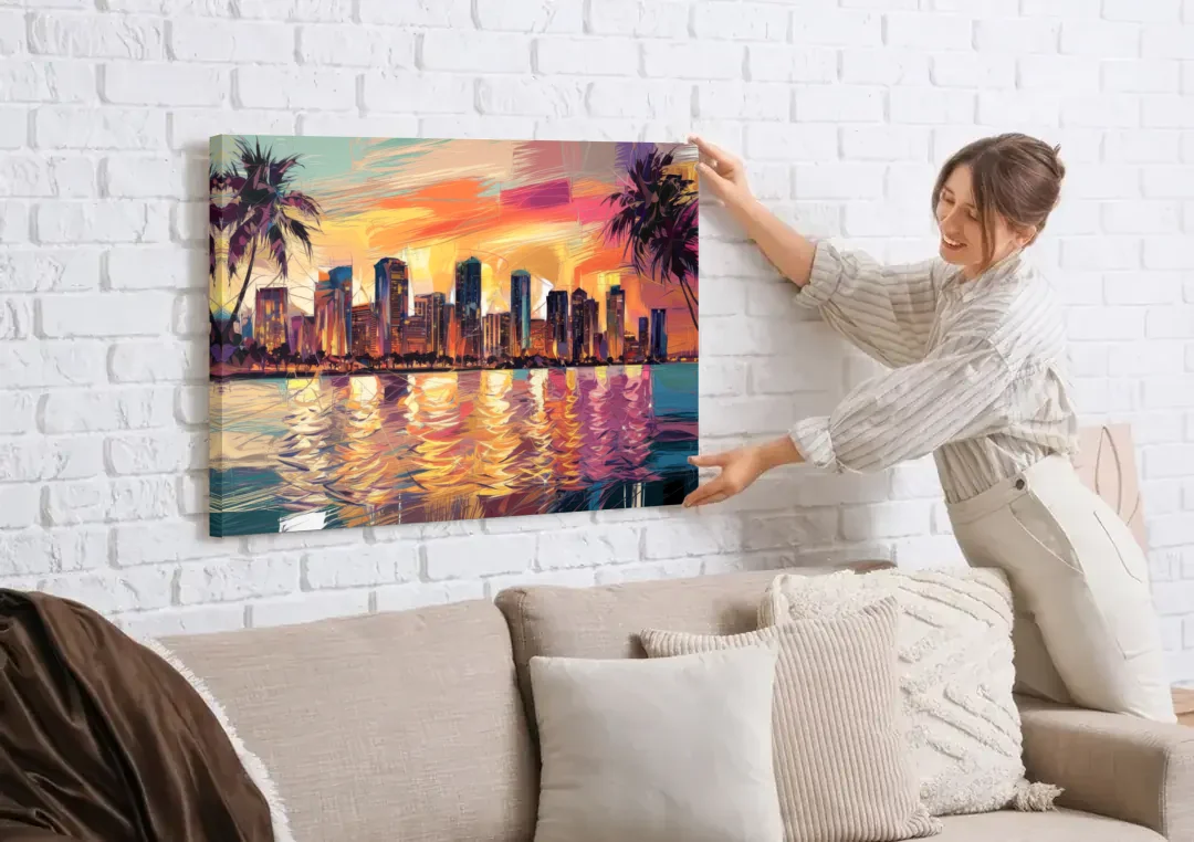 Miami Skyline At Sunset canvas wall art being hung on a white brick wall above a sofa