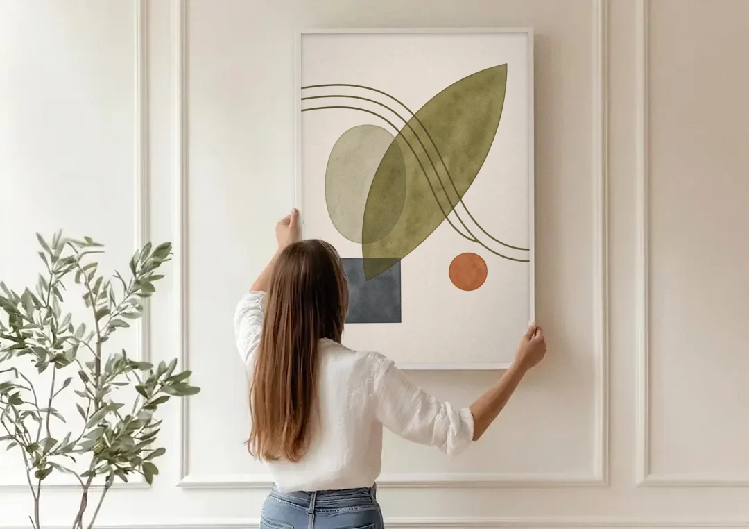 Mid Century Abstract Art with Leaning Olive Leaf canvas wall art being hung on a paneled wall