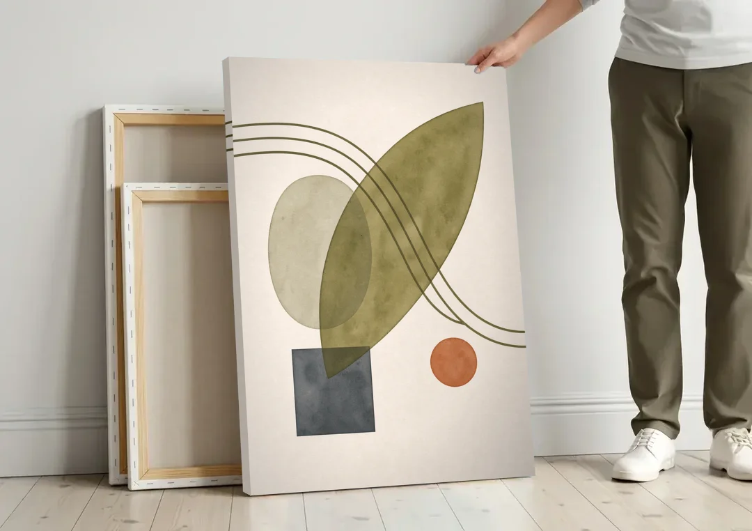 Mid Century Abstract Art with Leaning Olive Leaf canvas wall art leaning against a wall next to blank canvases